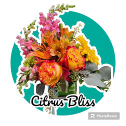 Bouquet of orange, pink, and yellow flowers with eucalyptus