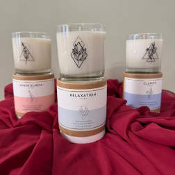 Three labeled candles on a red fabric backdrop