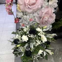 Black and white floral arrangement with roses and lilies