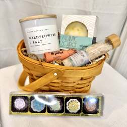 Gift basket with candles, soap, bath salts, and lip balm