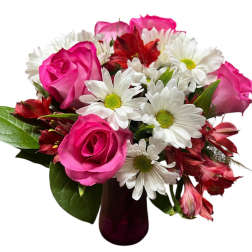 Pink roses and white daisies in a dark glass vase