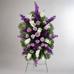 Standing floral spray with purple and white flowers on an easel