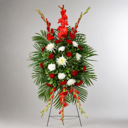 Standing floral spray with red and white flowers on a metal easel