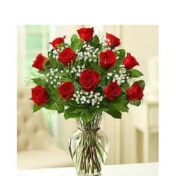 Red roses arranged in a clear glass vase