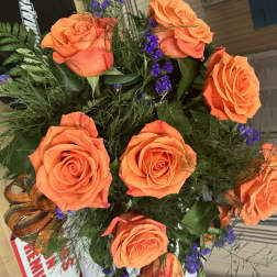 Bouquet of orange roses with purple filler flowers