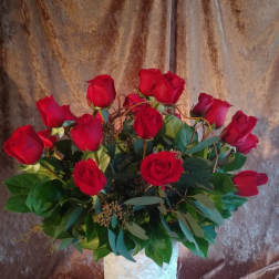 Red roses arranged in a white textured vase