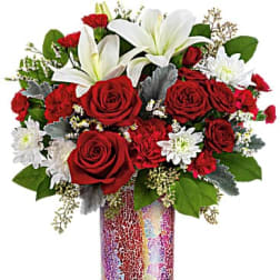 Red roses and white lilies in a mosaic glass vase