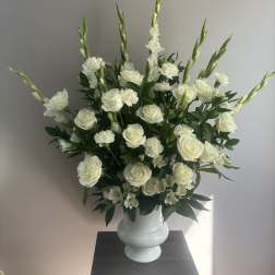 White roses and carnations in a white vase