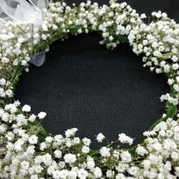 White baby's breath floral wreath with a sheer ribbon bow