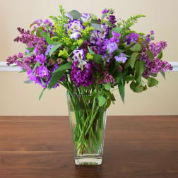 Purple mixed bouquet in a clear glass vase