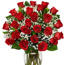 Bouquet of red roses and white baby's breath in a clear glass vase