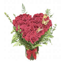 Heart-shaped bouquet of pink roses in a glass vase with a red ribbon