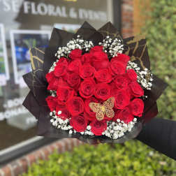 Bouquet of red roses with baby's breath in black wrap