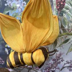 Decorative yellow and brown butterfly sculpture in a vase