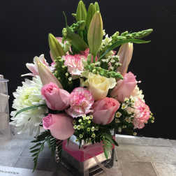 Pink and white bouquet with lilies, roses, carnations, and chrysanthemums in a clear vase