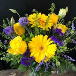 Yellow and purple mixed bouquet in a glass vase
