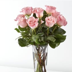 Pink roses arranged in a clear glass vase