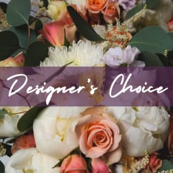 Mixed arrangement of white and peach flowers with roses and peonies, overlaid with text reading Designer's Choice