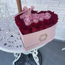 Pink box of red and blush roses with a ribbon bow