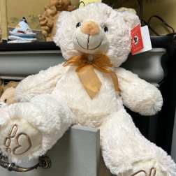 White teddy bear with a gold ribbon bow