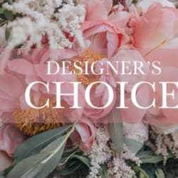 Pink floral arrangement with large blooms and white filler flowers