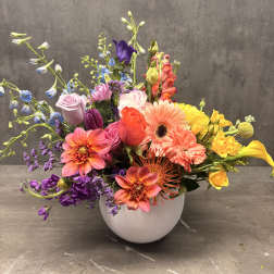 Colorful mixed bouquet in a white round vase