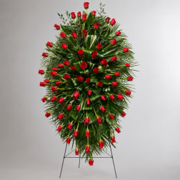 Standing spray of red roses on a metal easel