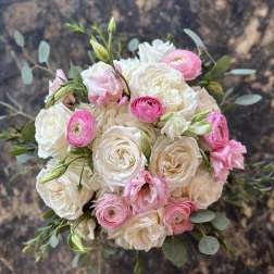 Bouquet of white roses and pink ranunculus with eucalyptus