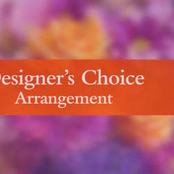Designer’s Choice Arrangement sign over a blurred floral background