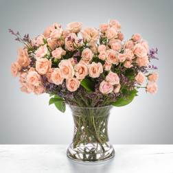 Bouquet of pale pink roses in a clear glass vase