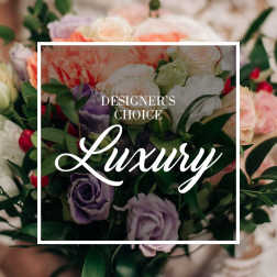 Mixed bouquet of pastel roses and purple blooms with greenery