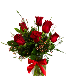 Red roses in a glass vase with a red ribbon