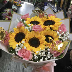 Bouquet of sunflowers and pink roses with white baby's breath