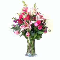 Pink and white floral bouquet in a clear glass vase