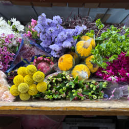 Assorted bouquets of colorful flowers wrapped in plastic