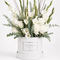White roses and gladiolus in a white hatbox with eucalyptus