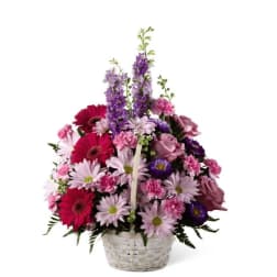 Basket arrangement of pink, purple, and red mixed flowers