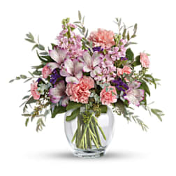Pink and purple mixed bouquet in a clear glass vase