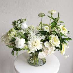 White floral arrangement in a clear glass vase