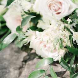 Blush roses with white filler flowers and greenery