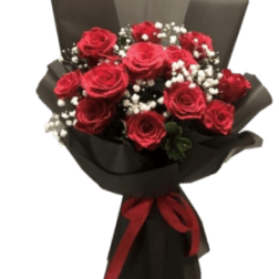 Bouquet of red roses with white baby's breath wrapped in black paper