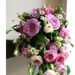 Cascade bouquet of pink and lavender flowers with small white daisies