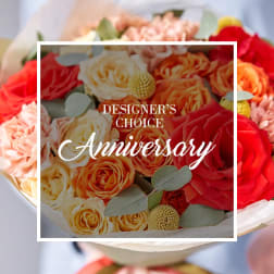 Anniversary bouquet of red, peach, and cream roses with mixed flowers and text overlay