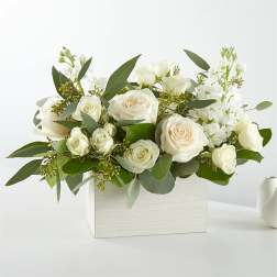 White roses and white blooms arranged in a white box