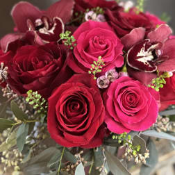 Bouquet of red roses and burgundy orchids with eucalyptus