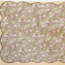 Floral-patterned scalloped fabric in pink and white on a green background