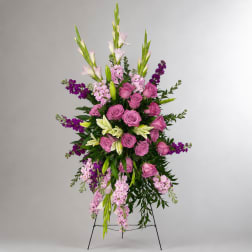 Tall standing floral spray with pink roses, lilies, and purple accents