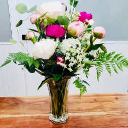 Pink and white flower bouquet in a clear glass vase