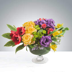 Colorful mixed bouquet in a green glass compote vase