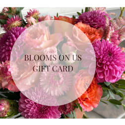 Gift card over a bouquet of pink, orange, and peach flowers